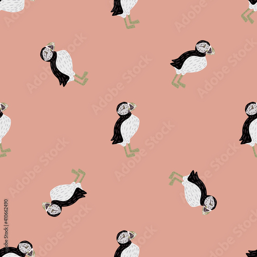 Seamless animal pattern in minimalistic style with doodle puffin bird shapes. Pastel pink background.