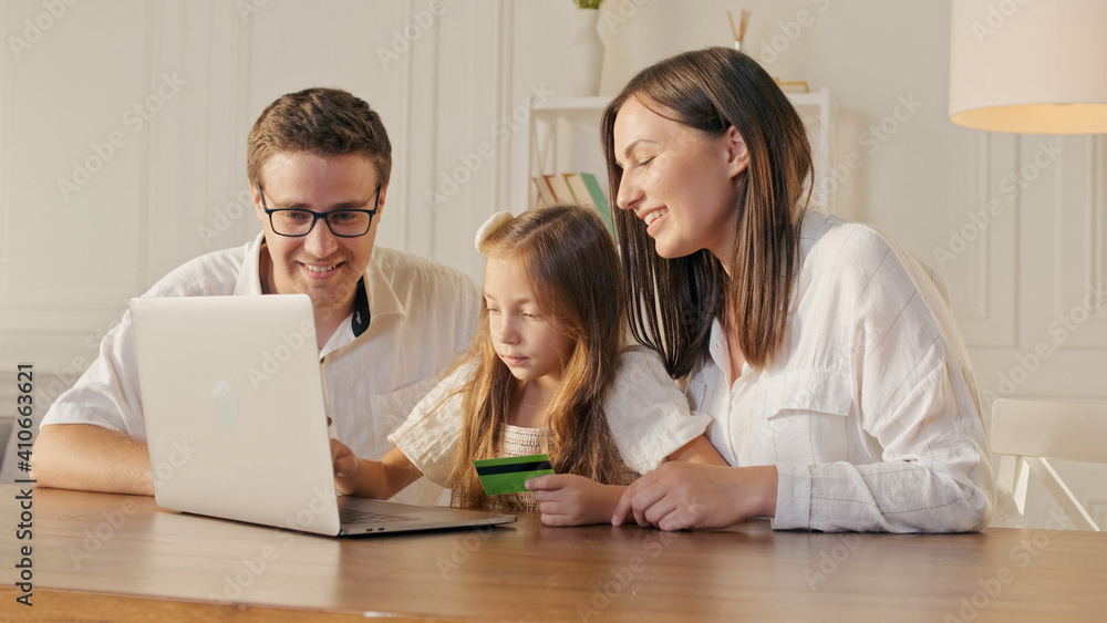 Parents With Child Use a Credit Card for Online Shopping. Buying by the Internet. Parents With Child Use a Credit Card for Online Shopping. Buying by the Internet.