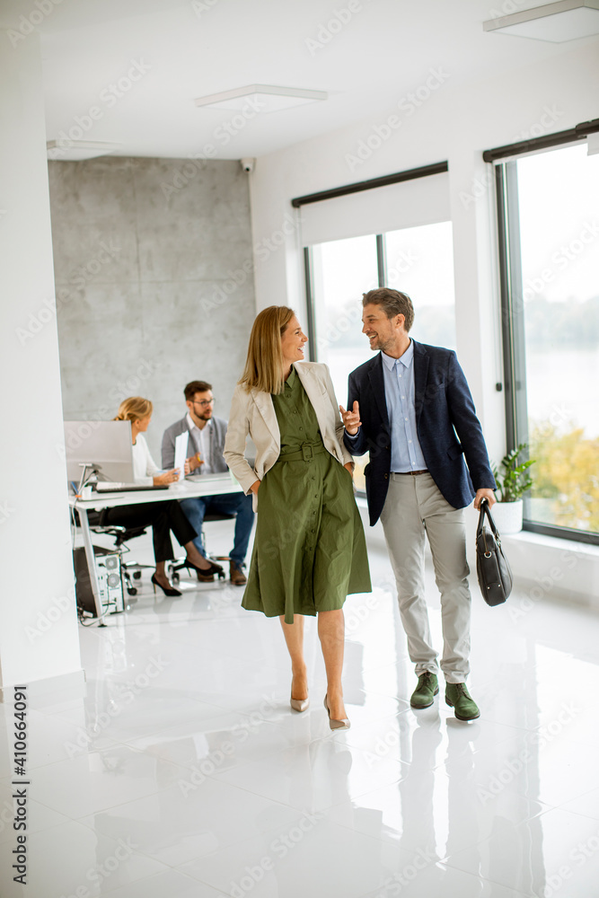 Young business couple walking together at office space Young business couple walking together at office space