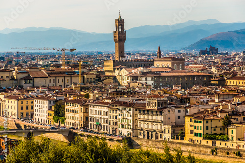 Great close-up view of the Palazzo Vecchio with the Arnolfo’s tower in the historic city centre of Florence with the hills of Settignano and Fiesole in the background, seen from Piazzale Michelangelo. photo