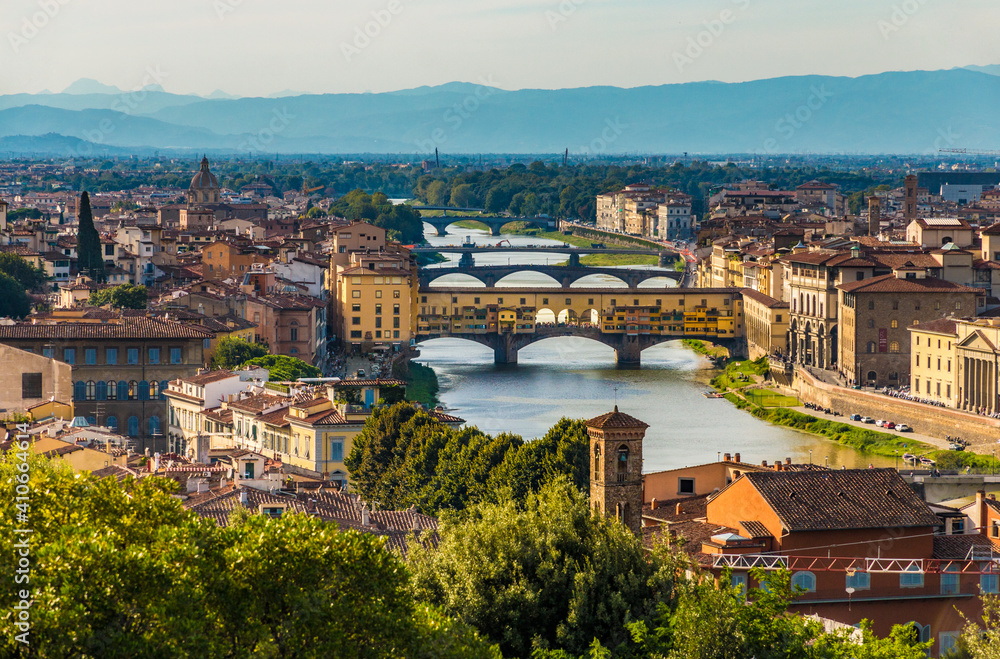 Gorgeous panoramic view overlooking the bridges crossing the Arno river, including the famous medieval Ponte Vecchio of the historic city centre of Florence at dusk, seen from Piazzale Michelangelo.
