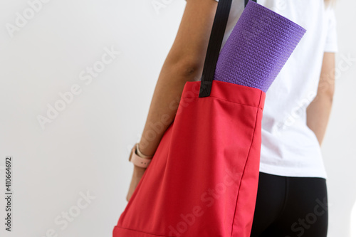 Close up of a womans hands is rolling up exercise mat and preparing to doing yoga.