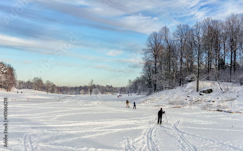 Skiers on a golf course on a sunny winter day in Stockholm, Sweden.