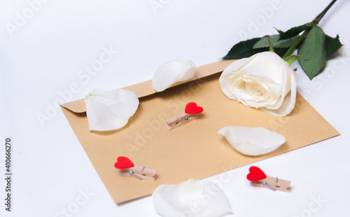  the rose lies on a paper envelope as a background. valentine's day celebration and eighth march concept
