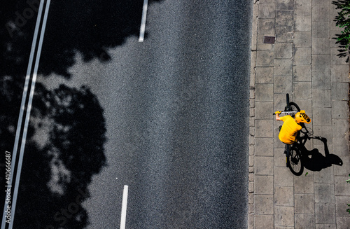 view from above on the person cycling streets of the city photo