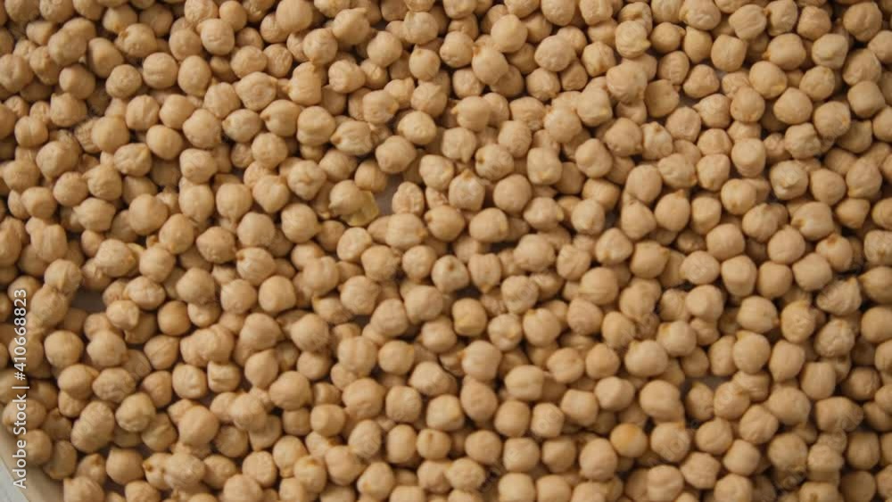 The rotation of the texture of chickpeas. Background. Rotating a plate of chickpeas. solid background, close-up.. The rotation of the texture of chickpeas. Background. Rotating a plate of chickpeas. solid background, close-up..