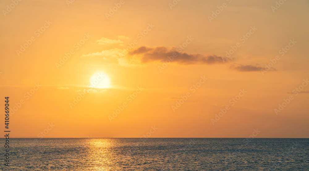 Sunset sky over sea in the evening with orange sunlight 