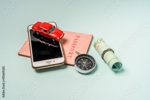 Travel items a toy car and passports on a blue background. Background for the holiday planning concept