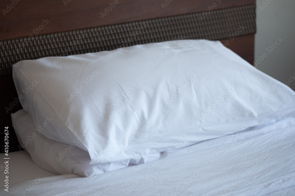 Stack of white soft pillows on comfortable bed sheet Stack of white soft pillows on comfortable bed sheet