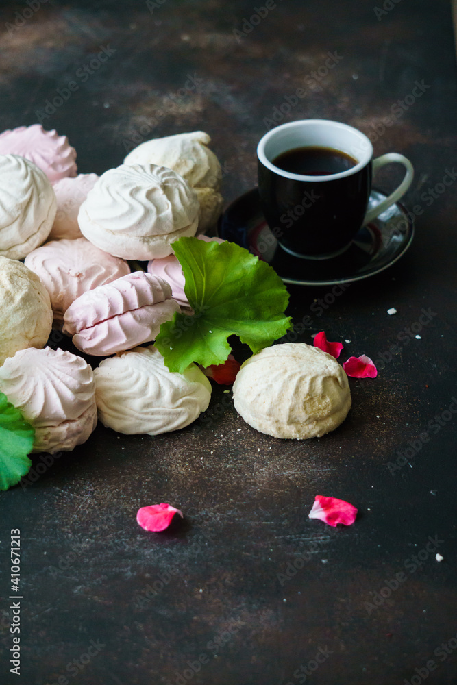 Delicious multicolored marshmallows on the table with a cup of coffee. Delicious multicolored marshmallows on the table with a cup of coffee.