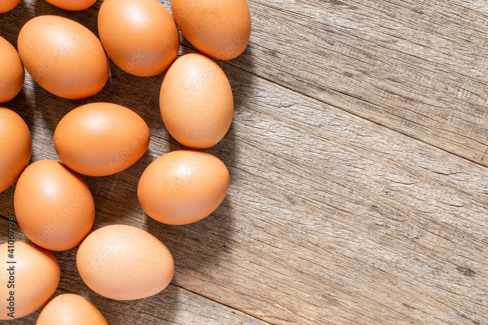 Chicken eggs on the wooden board background with a copy space. Flat lay. Chicken eggs on the wooden board background with a copy space. Flat lay.