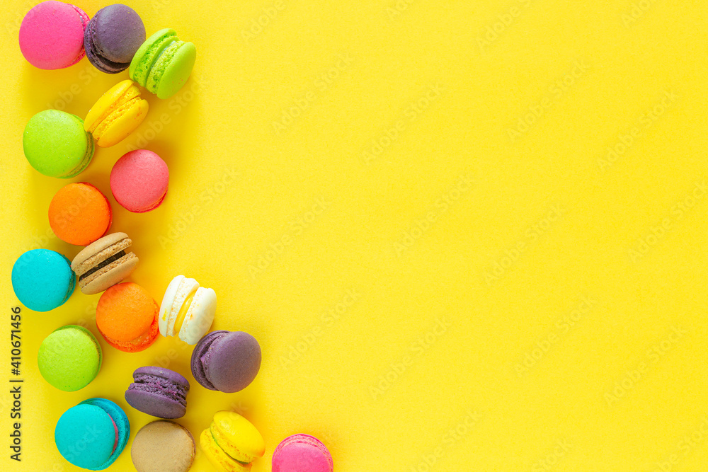 Sweet colorful macaroons on yellow background Sweet colorful macaroons on yellow background