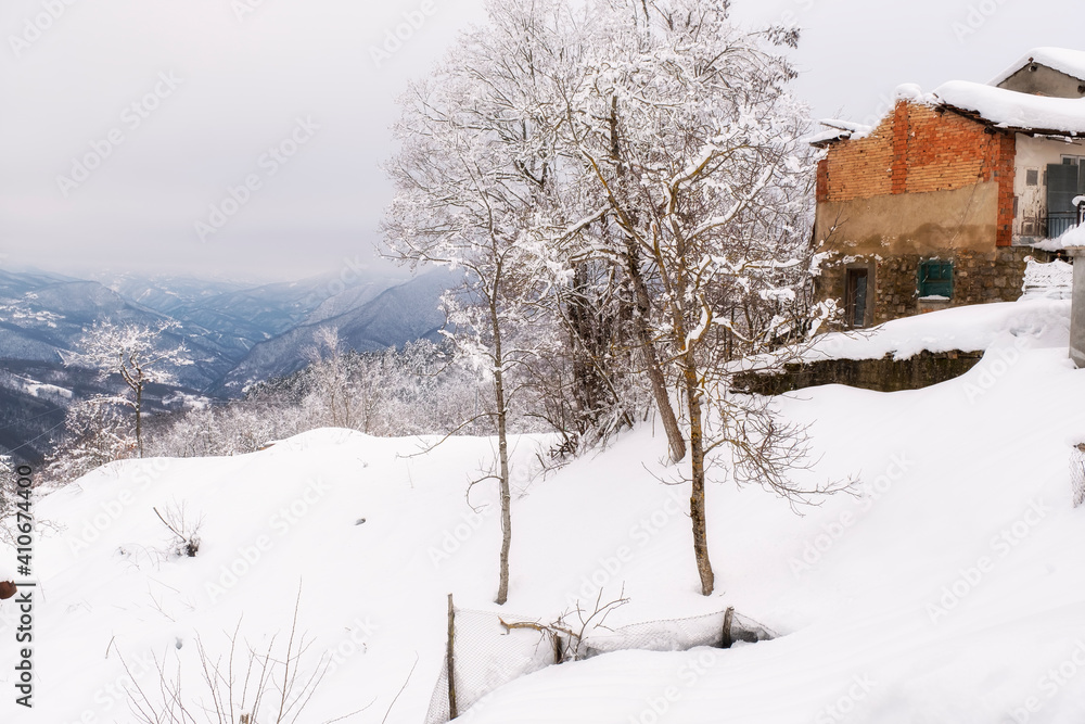Snowy panorama of the hills surrounding the village of Brallo (Lombardy, Northern Italy, Pavia Province), village in the hilly area of Oltrepo Pavese, along the road pass between Lombardy and Liguria. Snowy panorama of the hills surrounding the village of Brallo (Lombardy, Northern Italy, Pavia Province), village in the hilly area of Oltrepo Pavese, along the road pass between Lombardy and Liguria.