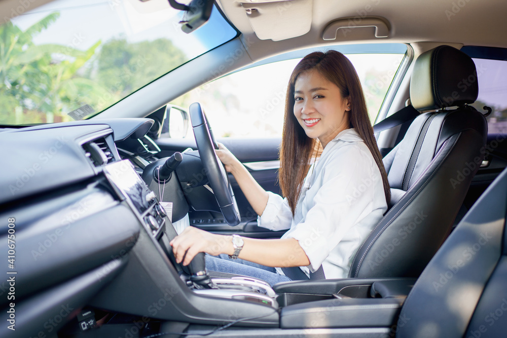 Asian woman smile and enjoy driving on vacation.