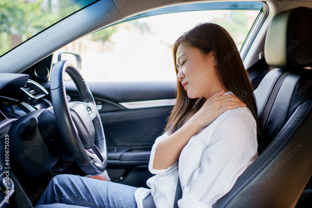 Asian business woman has shoulder and neck pain in the car Asian business woman has shoulder and neck pain in the car
