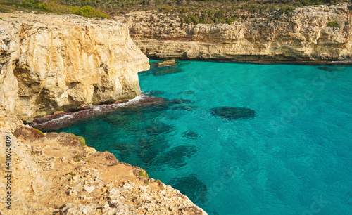 Clear blue green sea water  rocky cliffs around - nice sunny day at Ansa de s Estri  Mallorca