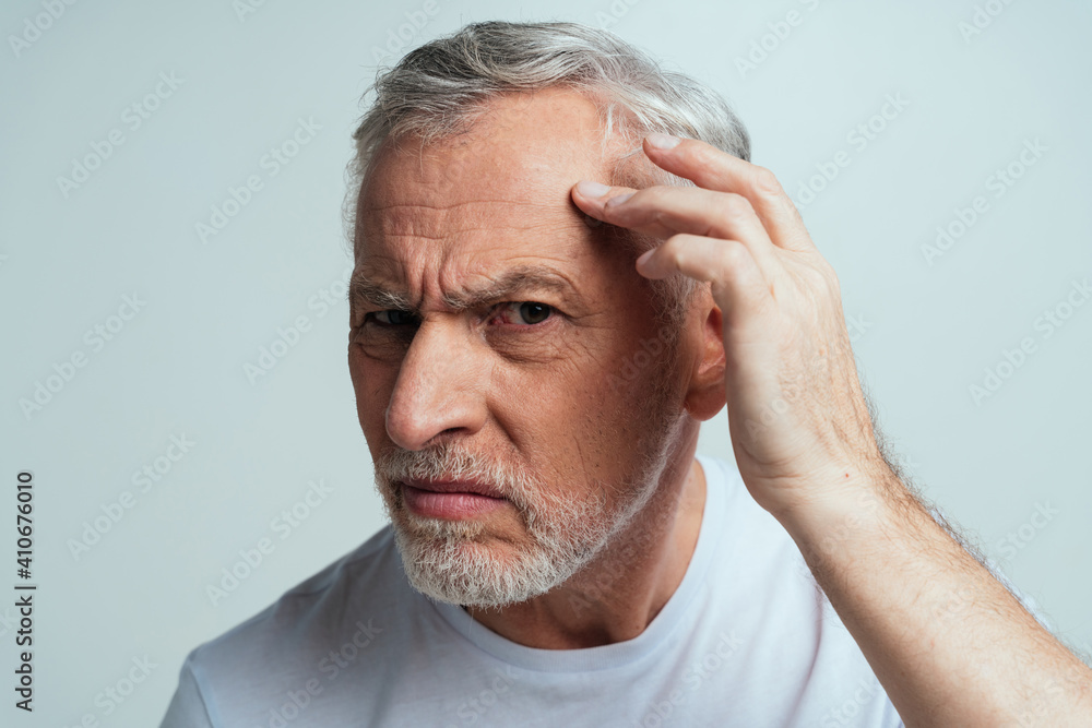 Obraz premium Handsome senior isolated on grey background. Concept about the third age and seniority