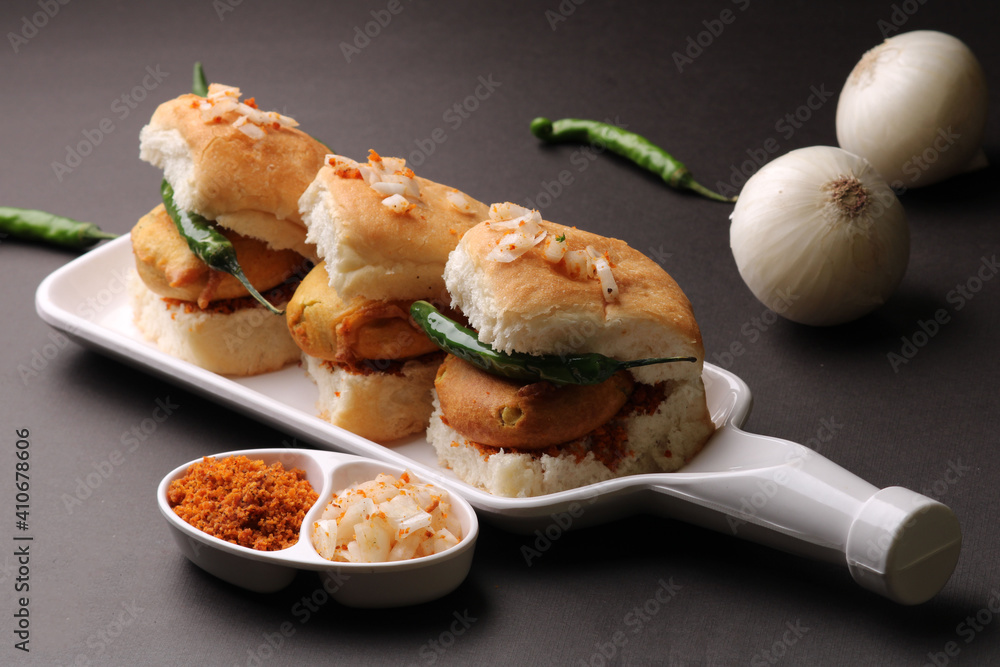 Bombay vada paav is an indian burger. Potato patty is deep fried in gram flour or besan batter and it is served hot with paav or bun like sandwich. Its available and liked all over India Bombay vada paav is an indian burger. Potato patty is deep fried in gram flour or besan batter and it is served hot with paav or bun like sandwich. Its available and liked all over India