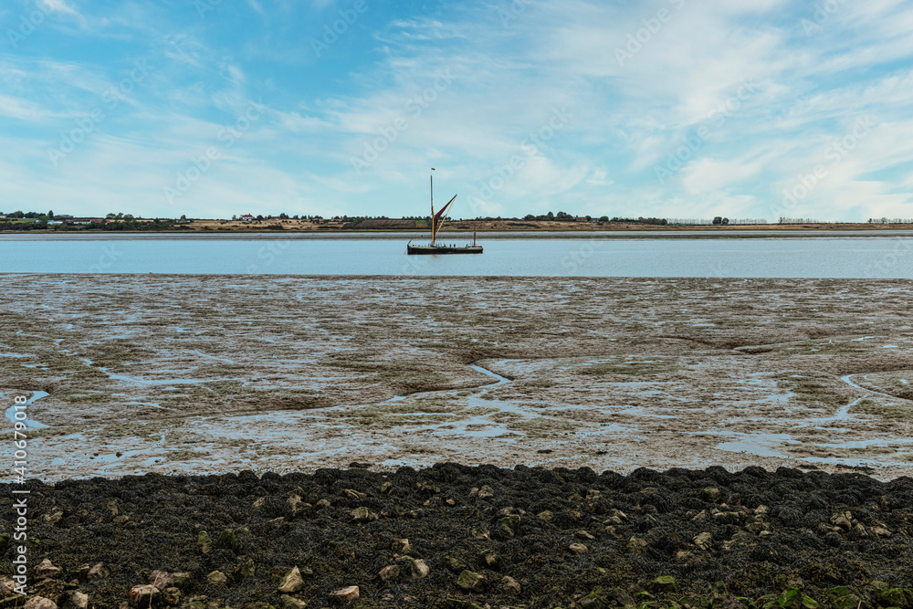 Sailing Barge on the Swale Estuary at low tide at Oare near Faversham in Kent, overlooking the isle of Sheppey Sailing Barge on the Swale Estuary at low tide at Oare near Faversham in Kent, overlooking the isle of Sheppey