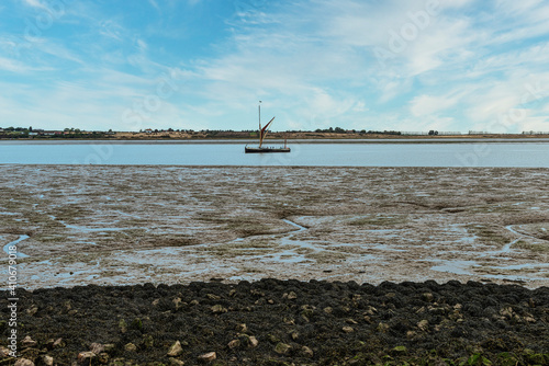 Sailing Barge on the Swale Estuary at low tide at Oare near Faversham in Kent, overlooking the isle of Sheppey