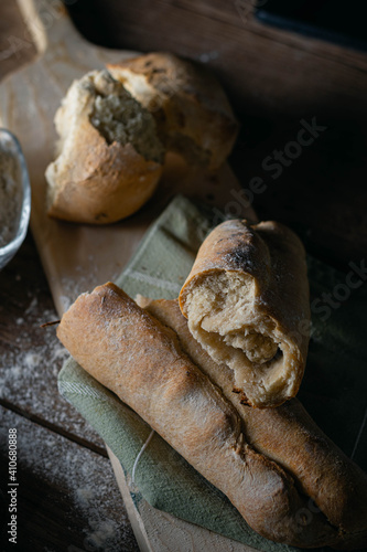 Hot homemade bread with moisture vapor freshly made in a Chilean clay oven with white flour and women's hands Cordoba Argentina