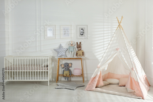 Fototapeta Naklejka Na Ścianę i Meble -  Comfortable crib and play tent in baby room. Interior design