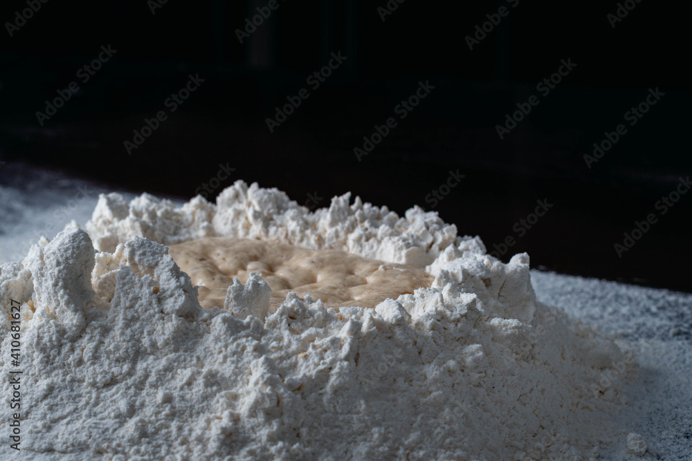 active fresh yeast in mountain of white flour with black background cordoba argentina active fresh yeast in mountain of white flour with black background cordoba argentina