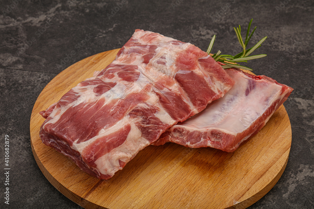 Raw pork ribs served rosemary