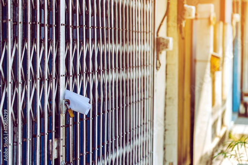 Fotografia White paper notification attached to closed retractable folding metallic gate