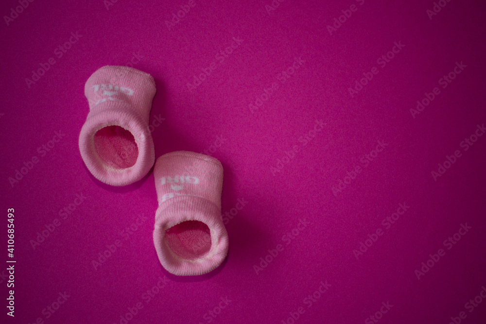 Newborn baby girl pink socks on pink background Stock Photo | Adobe Stock