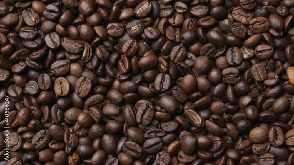Close up of fragrant coffee beans are roasted smoke comes from coffee beans.
Close up of fragrant coffee beans are roasted smoke comes from coffee beans.