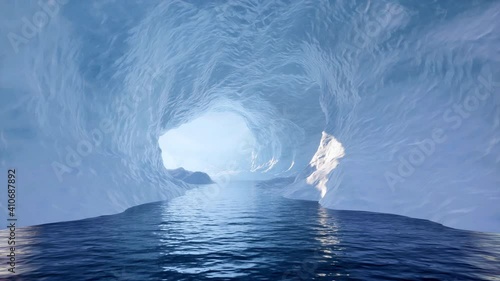 Traveling slowly through an ice cave and exiting the other side onto a beautiful ocean scene. photo
