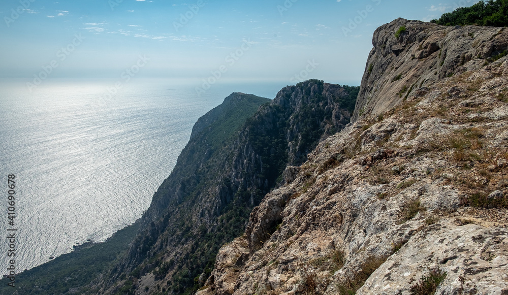 Fototapeta premium Mediterranean landscape. Forested rocks of the Black Sea coast of the southern coast of the Crimean Peninsula on a clear sunny day.