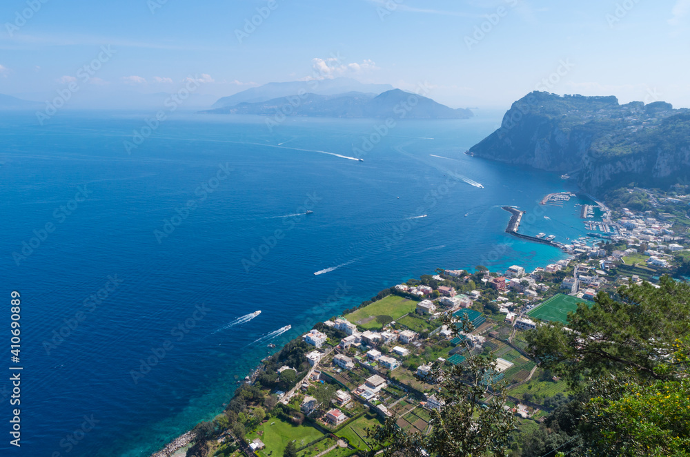Fototapeta premium A wonderful panoramic seascape towards the sea from Capri, South Italy. Boats, sky, water and mountains in the background.