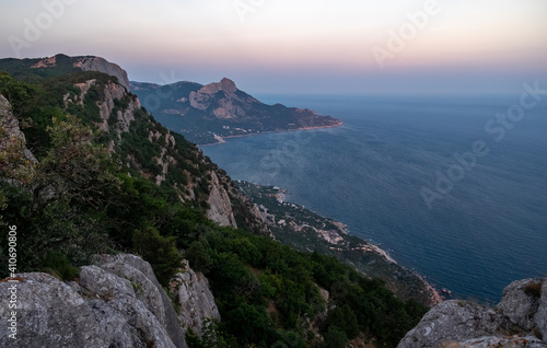 Mediterranean landscape. Forested rocks of the Black Sea coast of the southern coast of the Crimean peninsula at sunset.