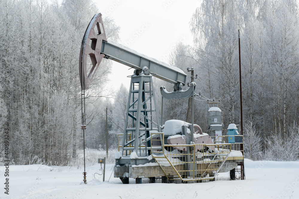 Oil rocking chair, winter landscape in Russia. Petroleum production in winter