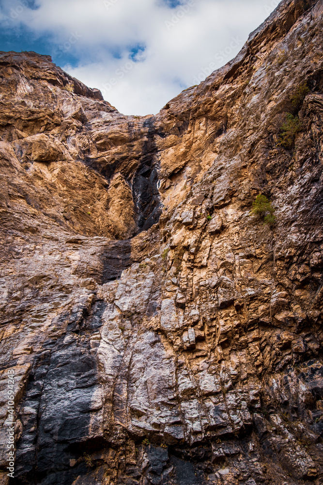 A fan waterfall that gets wider at the base of its descent near Colorado Springs USA during a dry summer with only a little water. A fan waterfall that gets wider at the base of its descent near Colorado Springs USA during a dry summer with only a little water.