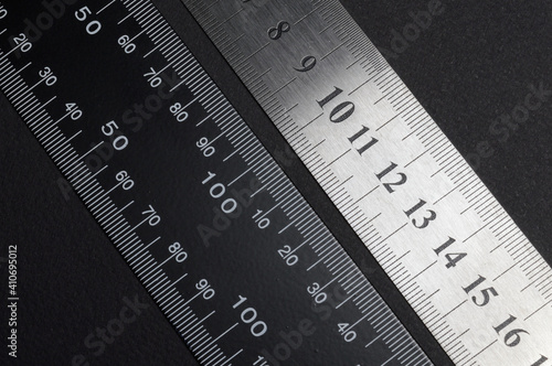 measuring tool, ruler square and caliper. lie on a dark background. close-up.