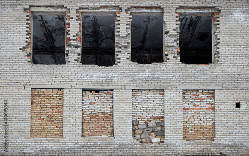 Foto abandoned silicate brick building with windows filled with bricks
