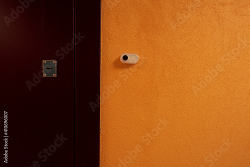 ypical ordinary corridor of a residential building, painted in bright colors, metal unnamed apartment doors, rich shades photo