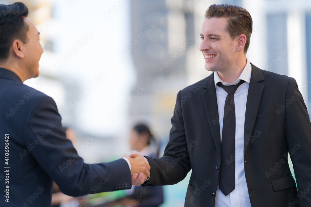 Close up, Handshake of two businessmen on the background of modern office, partnership concept