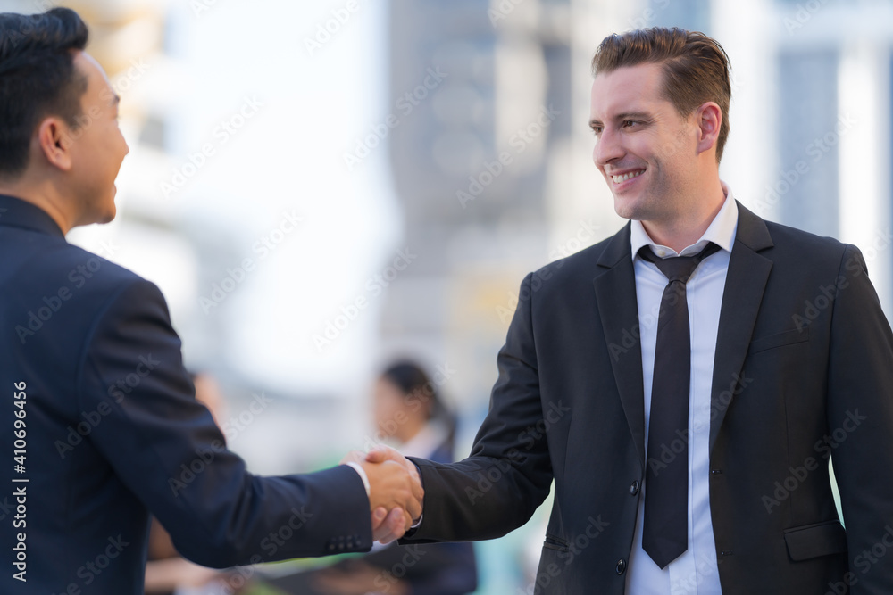 Close up, Handshake of two businessmen on the background of modern office, partnership concept Close up, Handshake of two businessmen on the background of modern office, partnership concept