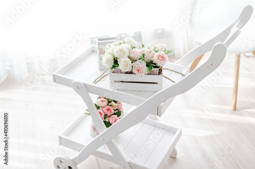 Fototapeta Naklejka Na Ścianę i Meble -  bouquet of artificial peonies and roses on a light wooden background