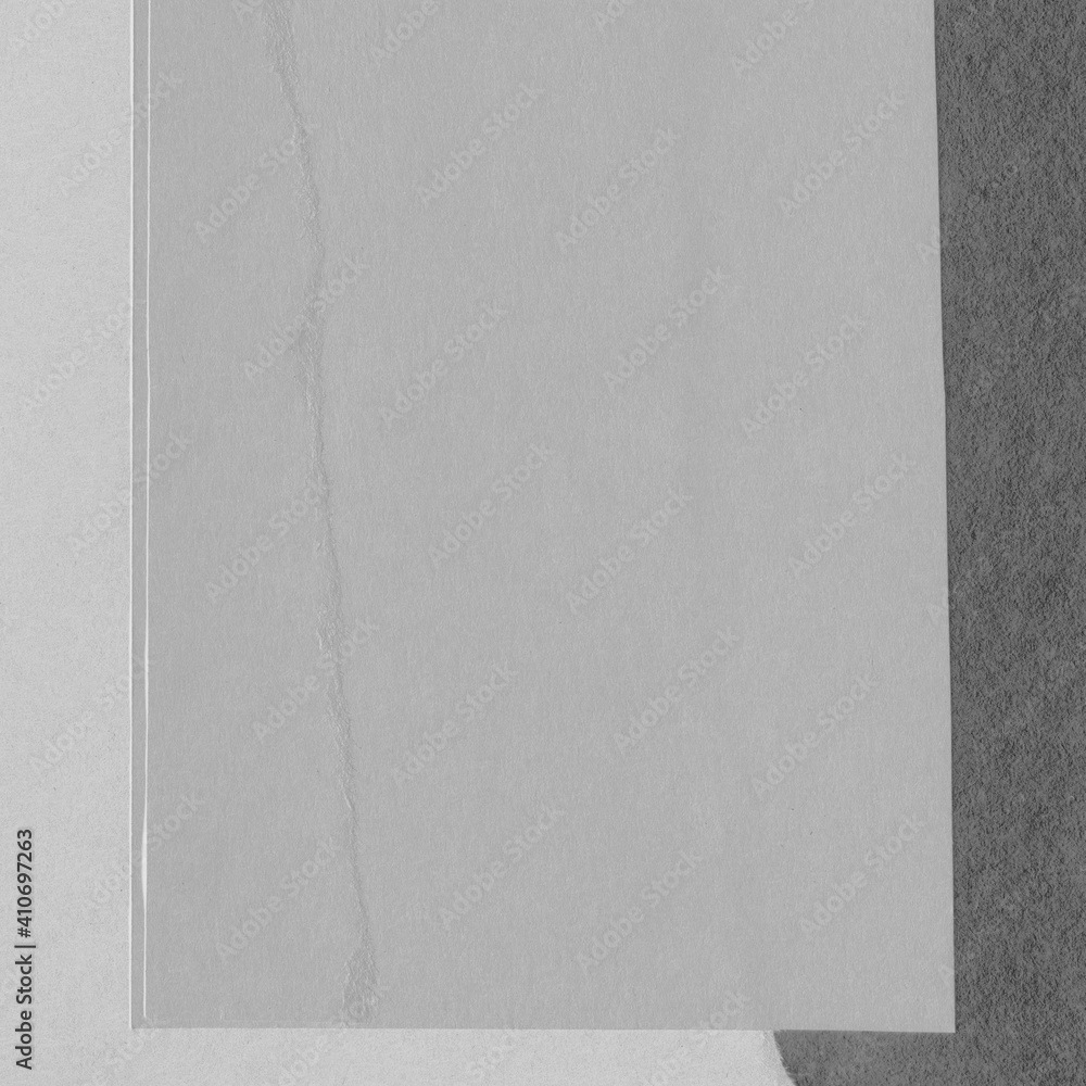 Fototapeta premium White torn paper collage close-up. Texture made from various paper and cardboard parts. Damaged old paper background. Vintage blank wallpaper. Material design backdrop.