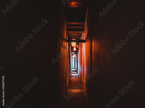 Fototapeta Narrow dark corridor illuminated with Chinese style lanterns