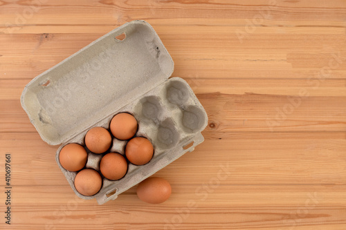 eggs in a package on a wooden table