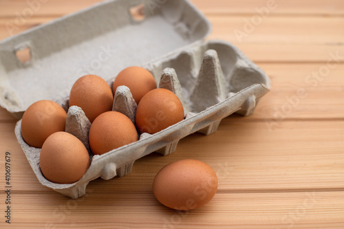 eggs in a package on a wooden table