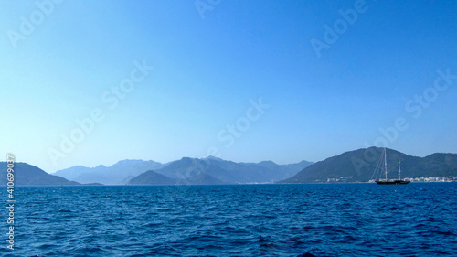 Boat in the sea with mountain background