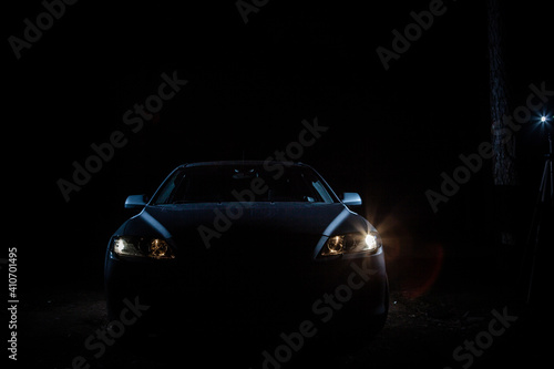 the headlights of an expensive car shine in the dark © KseniyaK