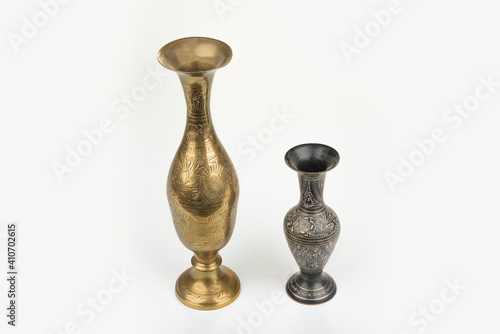 Gold metal carving vase on a white